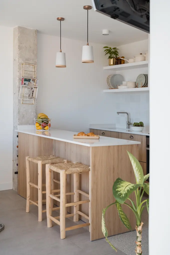 Isola cucina nordica con sgabelli e lampade pendenti Milano